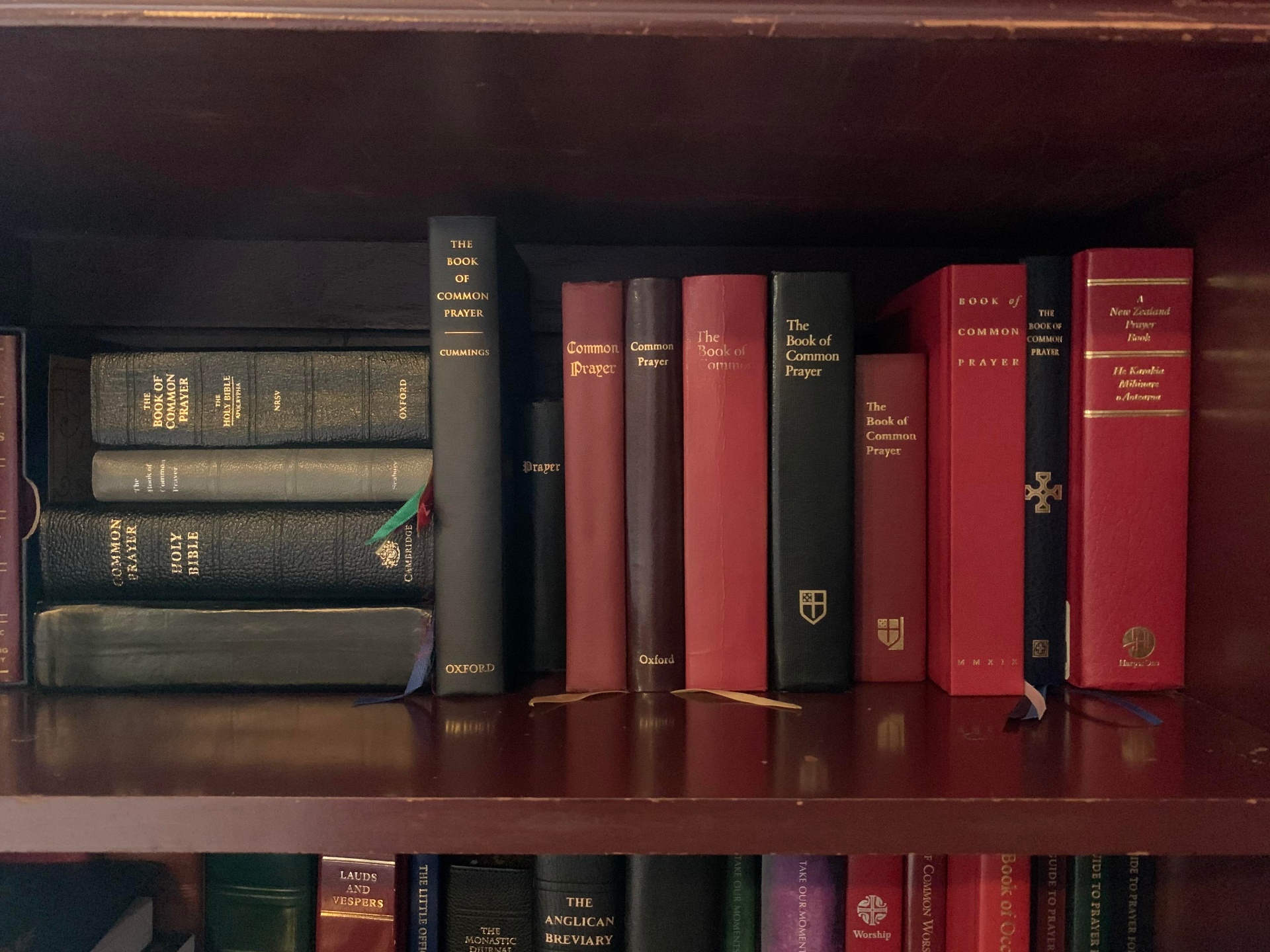 Shelf of Anglican prayer books and theological volumes